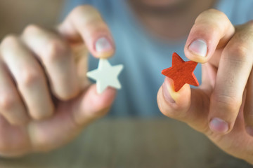 a man holding a red and white star