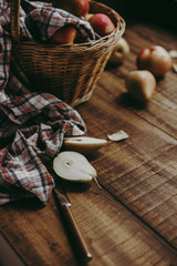 Autumn composition with cut colorful pears on wooden background