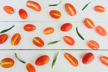 Rosemary tomatoes are placed on a white table.