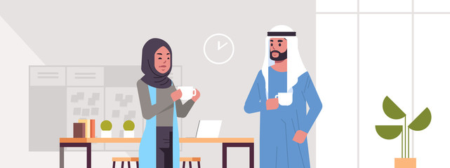 arabic businesspeople couple drinking cappuccino arab business man woman discussing during meeting coffee break concept modern office lounge area interior portrait horizontal