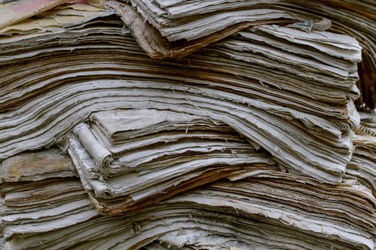 Stack old newspapers. Waste paper pile in vintage style. Abstract background. Close up. Environmental protection. - Powered by Adobe