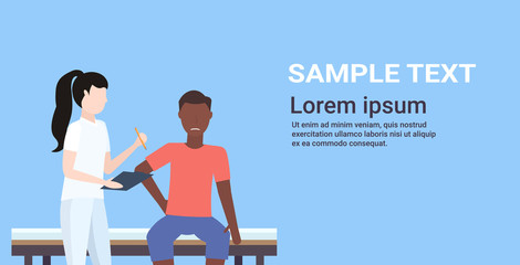 doctor holding clipboard female therapist consulting injured african american male patient sitting on bed manual sport physical therapy concept portrait horizontal copy space