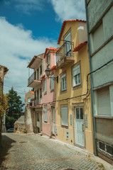 Colorful houses with public lamp on deserted alley