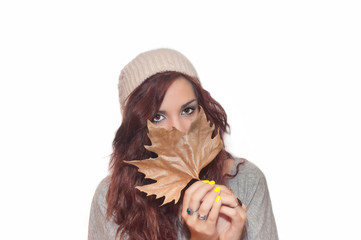 Young beautiful girl with autumnal leaf