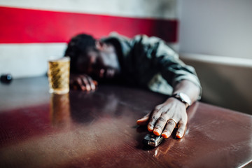 Drink no drive, say no for safety, no more alcohol concept. The man sitting in restaurant holding...