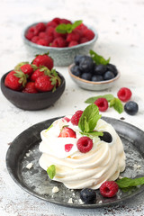 Mini Pavlova cakes with fresh berries