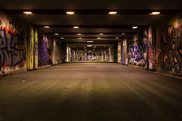 Croatia, Zagreb, June 21, the dark passage of a deserted, eerie creepy concrete indoor pathway grafted with graffiti at night
