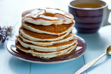 Healthy breakfast, homemade classic pancakes with caramel syrup.
