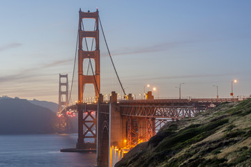 Twilight colors of the Golden Gate Bridge as seen from above Marshall's Beach. San Francisco,...