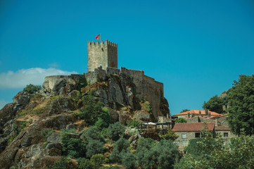 Fototapeta na wymiar Stone walls and tower of castle over rocky cliff