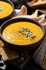 Delicious pumpkin soup in a bowl, vertical