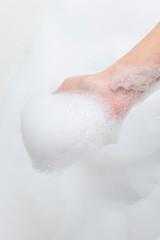 Hand with foam while bathing and cleaning the bathroom