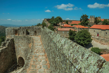 Pathway on stone wall with the front gate of castle