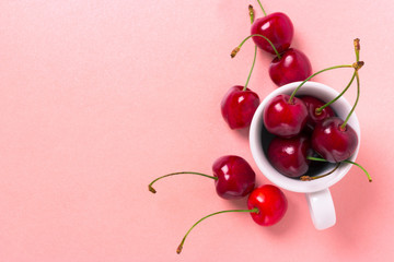 Obraz na płótnie Canvas Sweet cherry in the white cup