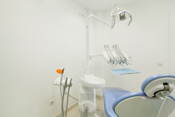 dental clinic room with blue dentist's chair