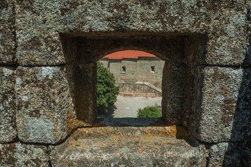 Close-up of arrow slit on stone wall of castle