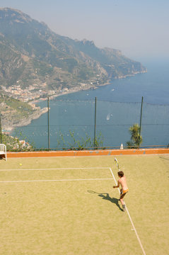 Boy playing tennis on holiday