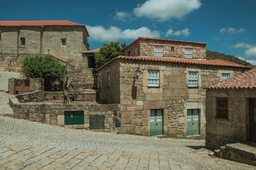 Fototapeta na wymiar Houses made of stone with deserted alley