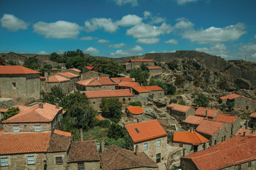 Fototapeta na wymiar Rooftops of stone houses and large wall