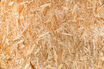 Chipboard sheet closeup, background blank. Texture of pressed wood shavings. Board sawdust under the press.