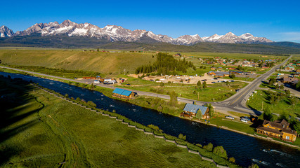 Aerial view of the famous high mountain town of Stanley Idaho with Sawtooth mountain range - obrazy, fototapety, plakaty