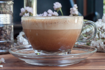 cup of coffee with cream and flowers