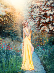 humanization of sunlight, slim girl in magnificent gentle seductive yellow dress of the Renaissance...