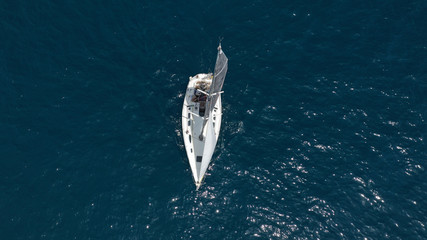 Obraz premium Aerial photo of sail boat cruising open ocean deep blue sea
