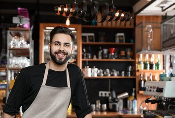 Portrait of smiling barista in coffee shop. Space for text