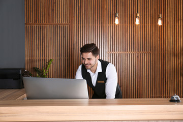 Portrait of receptionist at desk in lobby