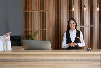 Portrait of receptionist at desk in lobby