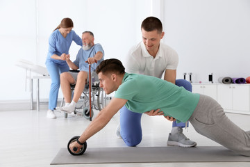 Professional physiotherapists working with patients in rehabilitation center