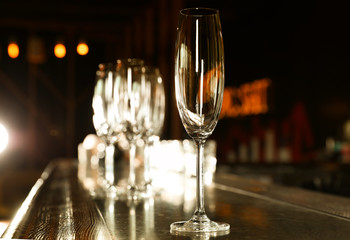 Empty clean champagne glass on counter in bar