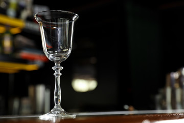 Empty clean glass on counter in bar. Space for text