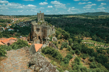 Stone castle and tower over rocky cliff