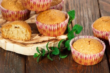 Vanilla cupcake, homemade pastry on wooden background