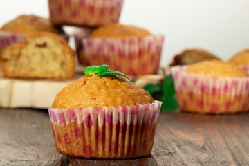 Vanilla cupcake, homemade pastry on wooden background