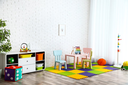 Stylish Playroom Interior With Toys And Modern Furniture