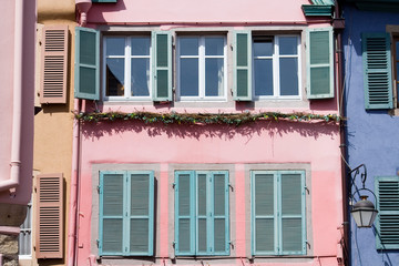 Fototapeta na wymiar Rose facade with 3 opened and 3 closed green windows