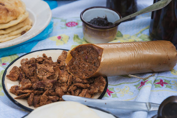 various homemade sausages and bacon served on a plate