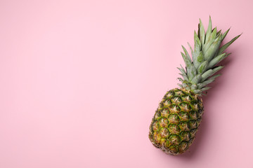 Fresh whole pineapple on pink background, top view. Space for text - obrazy, fototapety, plakaty