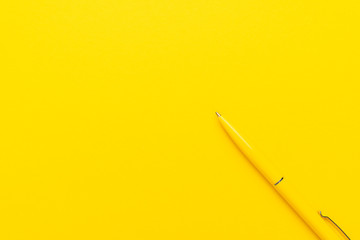 ballpoint pen on the yellow background. top view of yellow ballpoint pen with copy space