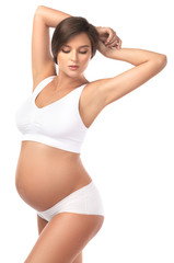 Fototapeta premium Young and beautiful pregnant woman on white background