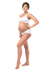 Young and beautiful pregnant woman on white background