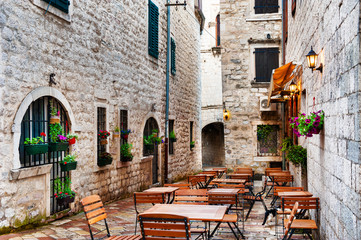 Cafe on the street in Old Town in Kotor, Montenegro. Famous travel destination.