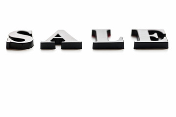 The inscription SALE. SALE in black blurred letters on a white background. Photo of the lettering, close-up