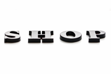 The inscription SHOP. SHOP in black bulk letters on a white background. Photo of the lettering,...