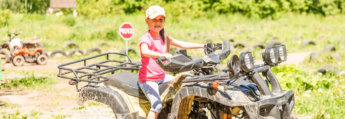 Little girl riding ATV quad bike in race track © Angelov