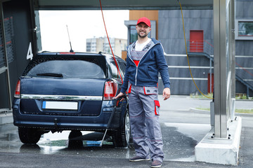 Car wash worker is washing client's car