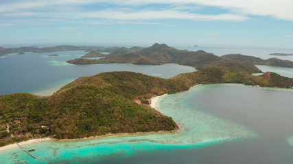 aerial view tropical island with sand white beach. Bulog Dos, Philippines, Palawan. Seascape bay with turquoise water and coral reef.